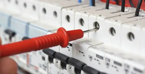 Electrical contractor testing circuit breakers during electrical repair in Newtonville, MA
