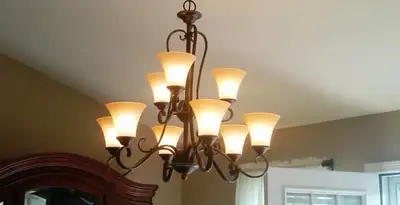 Classic ceiling chandelier installation with warm lighting in Waltham, MA