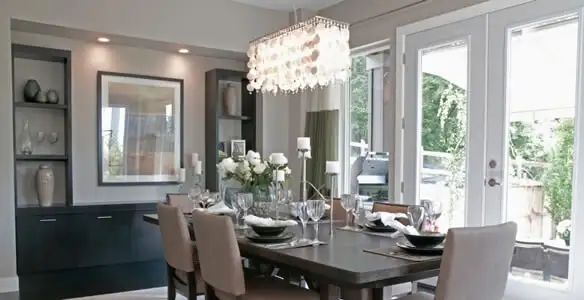 Elegant dining room chandelier installation above table in Waltham, MA