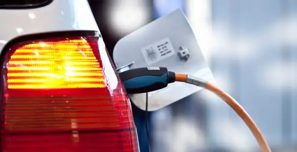 Electric car plugged into EV charger after professional installation in Waltham, MA