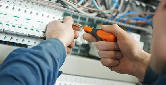 electrical service showing licensed electrician performing electrical panel maintenance and adjustments in Waltham, MA