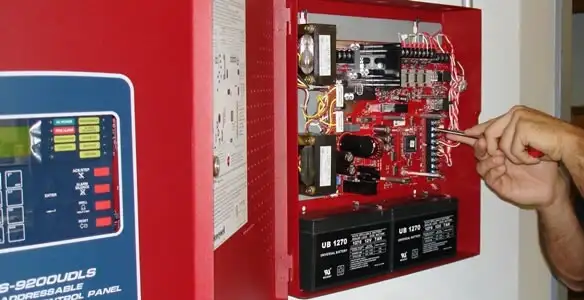 fire alarm installation service showing technician configuring fire alarm control panel in Waltham, MA
