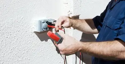 Electrician performing home electrical outlet and wiring inspection in Waltham, MA