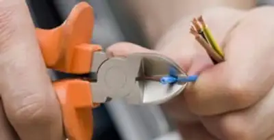 professional electrical services showing precise wire cutting by licensed electricians in Waltham, MA