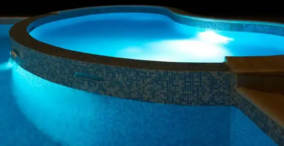 pool light installation and repair services highlighting illuminated pool interior lighting in Waltham, MA