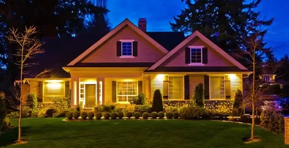 security light installation services illuminating a residential exterior at night in Waltham, MA