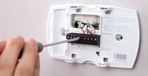 Thermostat installation service with proper wiring and secure wall mounting in Waltham, MA