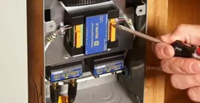 Whole home surge protection device being installed by a licensed electrician to protect electrical systems in Waltham, MA